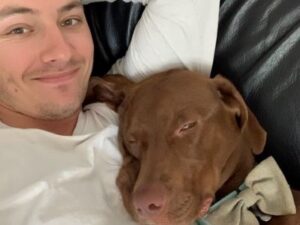 A selfie - Hennessy cuddled up again his new dad, on the sofa, Hennessy is wearing a bow tie