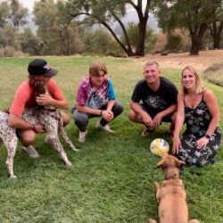 Bruno2 with his new family on a grassy lawn