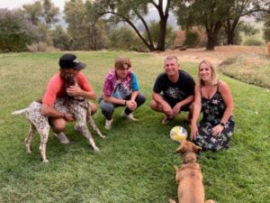 Bruno2 with his new family on a grassy lawn