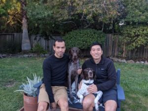 Maverick with his new dads and GSP brother