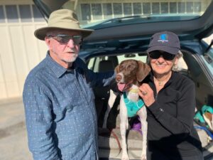 Cora in hatch of SUV with new mom and dad
