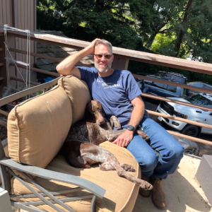 Viv sprawled on an outdoor sofa with her forever dad