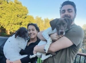 Maisie with her new mom and dad and fur sister.